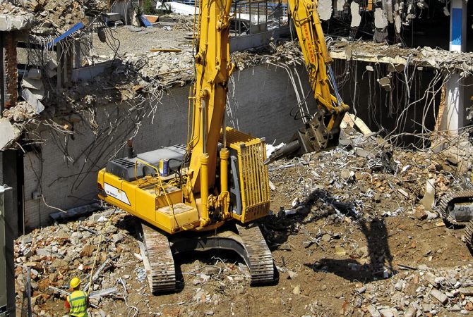 Excavator on a demolition site, London UK